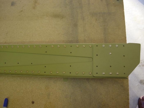 Holes not riveted are for the wing walk ribs and flap brace
