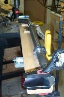 The torque tube mounted and clamped onto a board.