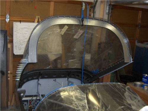 Canopy held open with overhead strap to gain acess inside for riveting side skirts