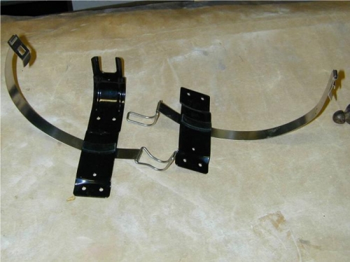 Bracket mounting strap on left, before cutting off end section (as on right one)