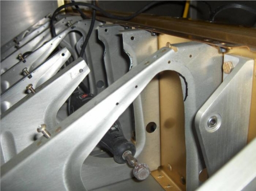 Denoted additional cutout of center seat ribs to allow full rotation of control bar.