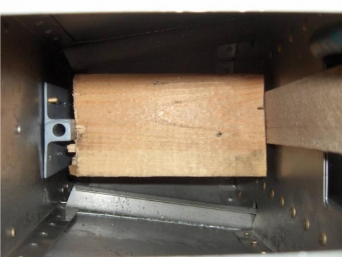 Wedging bracket against bulkhead for riveting