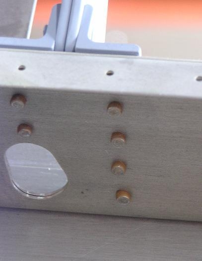 Near perfect rivets on hinge bracket