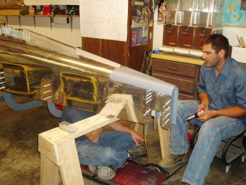 riveting back portion through the hole in the bulked