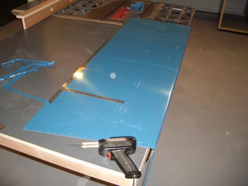 Removing film from holes