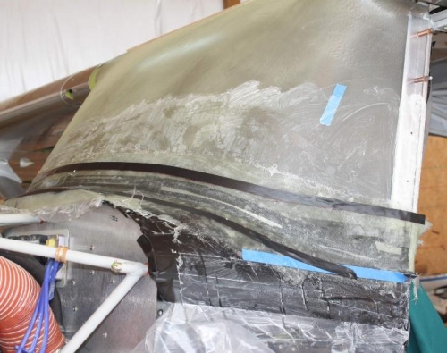 Fiberglass cloth epoxied in place, tape aligned with trimming lines.