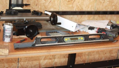 Angle iron screwed onto digital level.