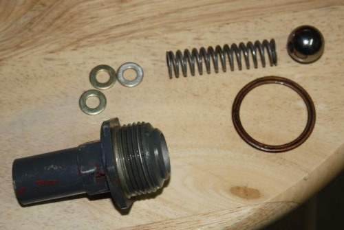Oil pressure relief tower, component parts including three washers.
