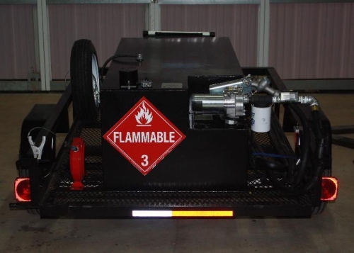 Aft view showing ground reel, pump and filter, spare tire and flammable sign.