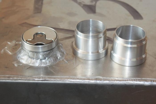 Gas cap, turned and unturned retainer ring, left to right.