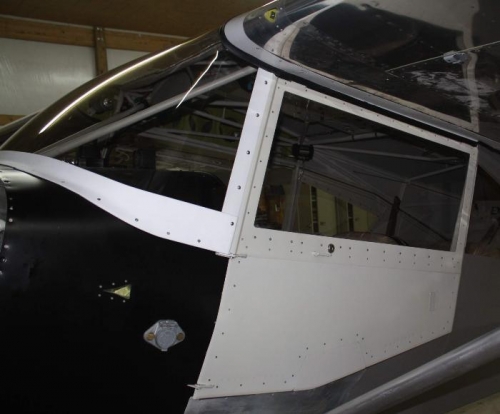 Left front door mounted, window closed..