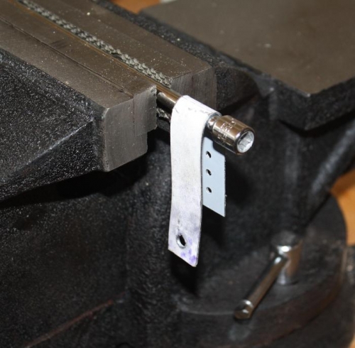 Strap bent over 1/4 inch socket extension.