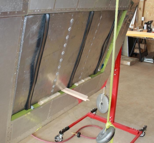 Straps prior to tightening, shimmed and pried forward for attaching the top straps.