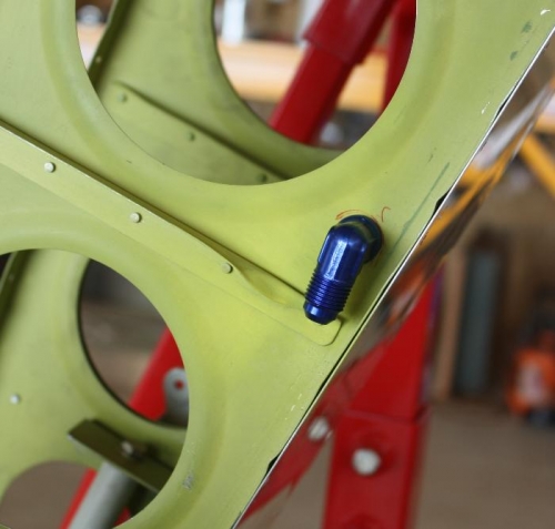 Inboard aft fuel line fitting with bent stiffener.