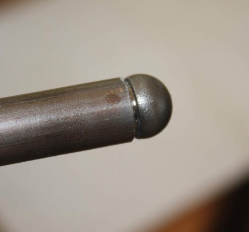 Button hacksawed all around.