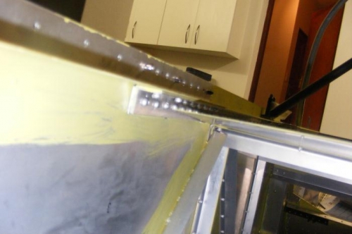 Shim inserted between skin and longeron.