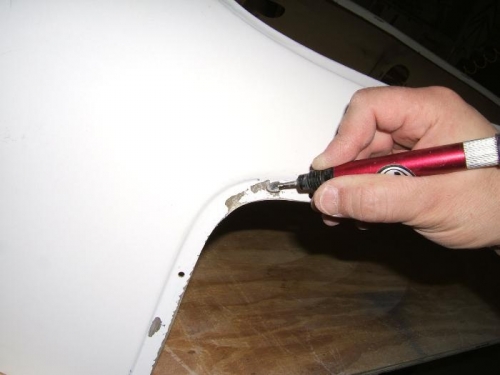 Prepping air pockets in the gel coat for filling