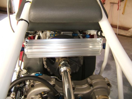 Finned oil cooler mounted in frame