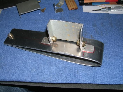 Brackets riveted to blade cradle