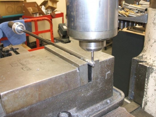 Hole for travel limit bolt