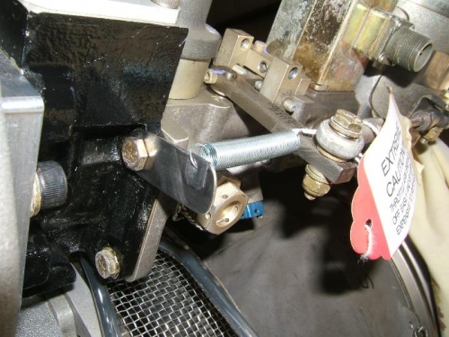 Return spring attachment from stainless strap