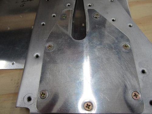 Trim reinforcement cover dimpled for screws.