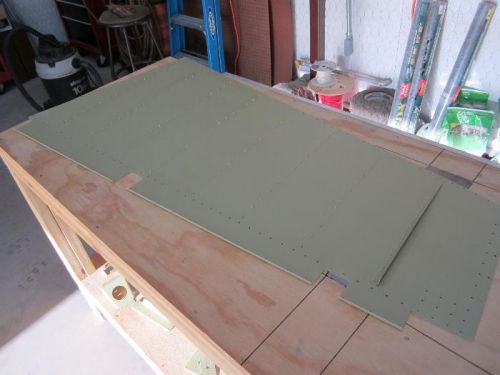 Back-riveting with metal plate in bench.