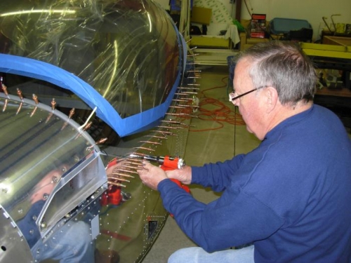 Riveting and screwing canopy to frame.