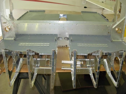 Riveted seat floor assemblies