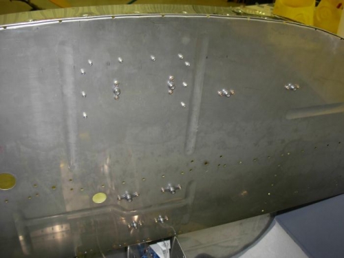 Cowl hinge riveted to firewall