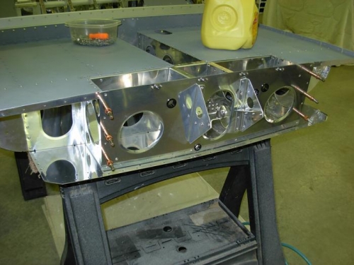 Riveted baggage bulkhead to baggage ribs