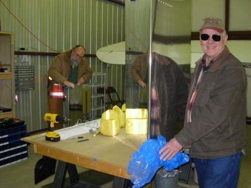 Jim Olson deburing while Jack Ryan removes blue covering from surface skin.