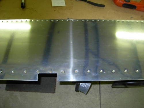 Forward fuselage skin debured and dimpled.