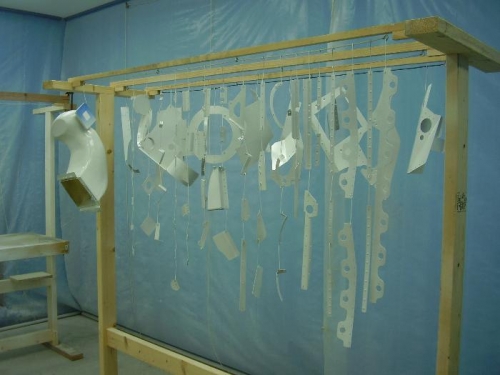 Primed parts hanging for drying