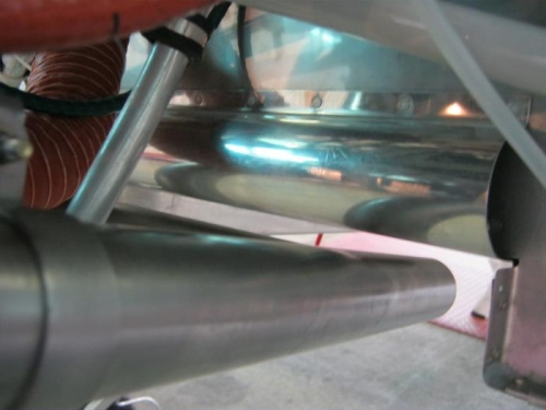 Exhaust tips repositioned above the lower hinge pin line
