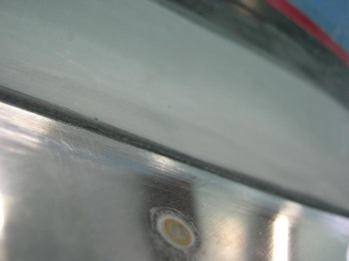 Botoom left windscreen to skin  fairing edge thru 3 layers of vinyl tape