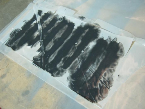 Some strips with pigmnented epoxy applied and covered in plastic to spread evenly