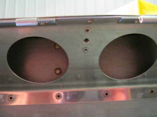 Plate nut holes drilled at aprox center location along flap hinge