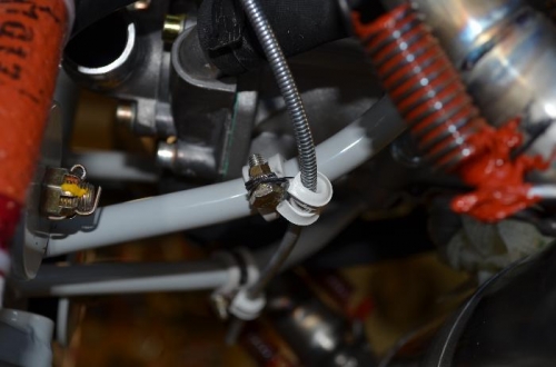 Cushion clamps holding cable to engine mount