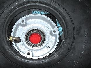 Tire installed over the rim with the stem through the hole in the rim.