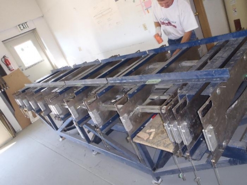 Horizontal halves held together by Jig for hysol cure