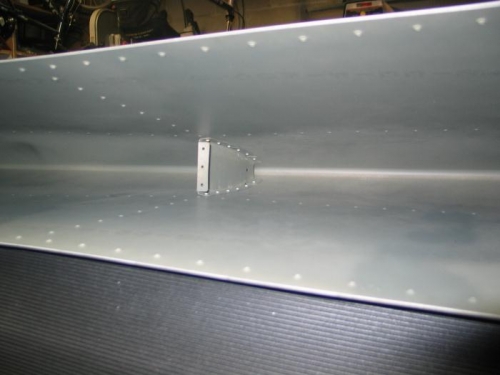 Rivet front rib into left horizontal stabilizer skin