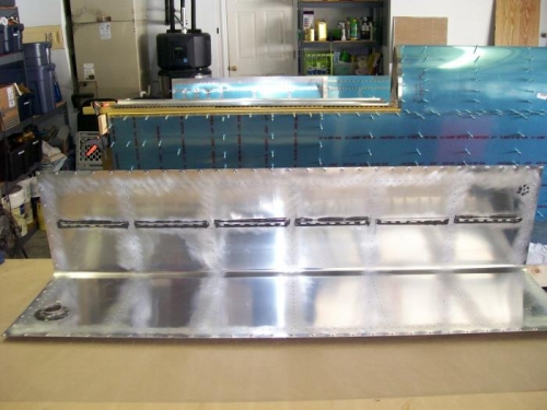 Tank with stiffeners, drain fitting and filler cap installed