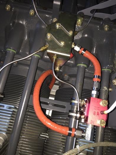 Top of engine where fuel line exists intercyl to red cube, then to divider