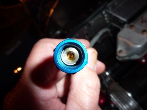 Brass orifice inside oil pressure line.