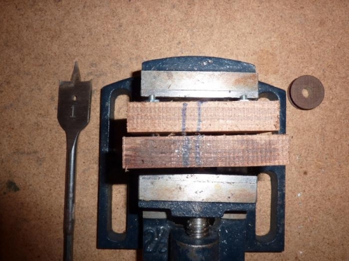 Side view of wheel clamped between 2 pieces of wood