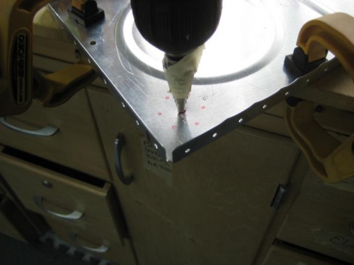 using a step drill to make the large hole