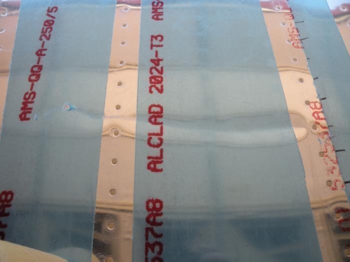 The gouge and dent on the outside of the F-776 center fuselage bottom skin.