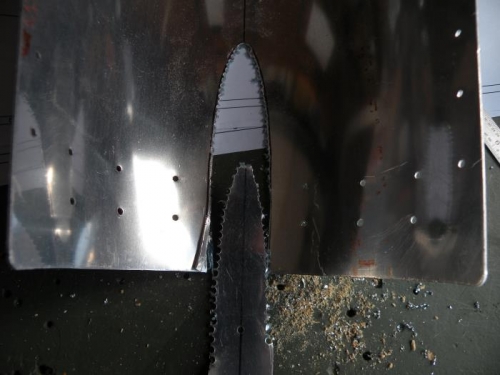 I started with shears, but had to finish with a #40 drill.