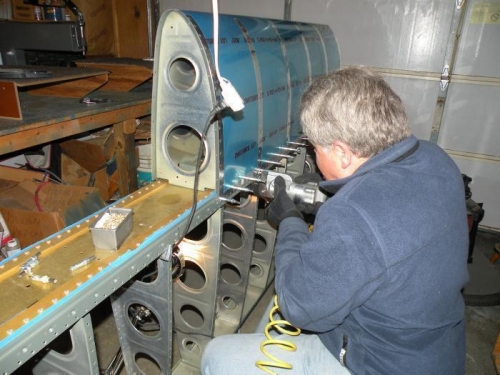 Riveting the right leading edge skin to the spar.